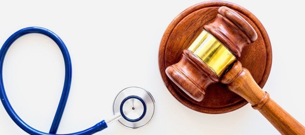 Medical law, health law. Gavel and stethoscope on white backgound top view copy space